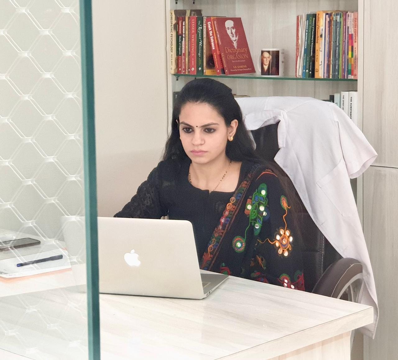 Dr. Ria reviewing a case at her desk